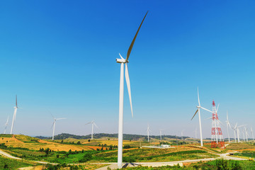 wind turbines on the hill with blue sky background