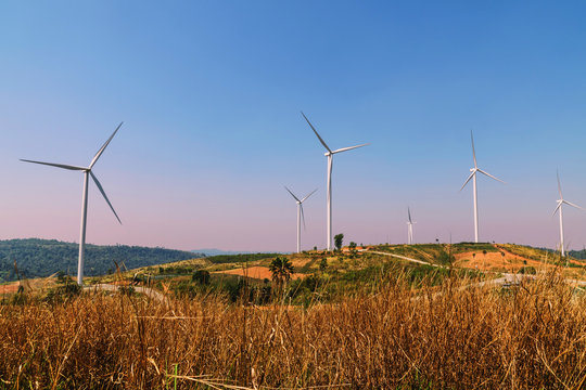 wind turbines on the hill with blue sky background