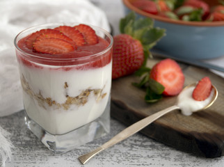 Homemade natural yogurt with strawberries and muesli.