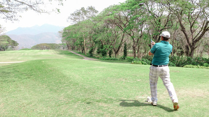Golf ball on tee ready to be shot at beautifull golf course .