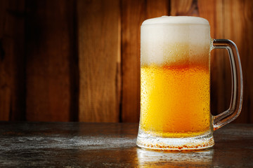 mug with beer on a wooden background