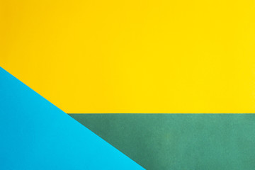 Combined multicolored decorative background. The main color is yellow and additional - green and blue. Copyspace, flat lay, top view