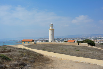 Fototapeta na wymiar The old lighthouse in the background of the town of Paphos located on the island of Cyprus in the Mediterranean Sea