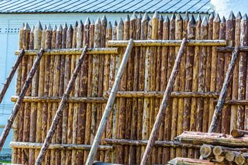 Medieval wooden fence made of palisade