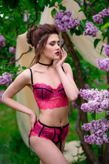 Fototapeta premium Woman in red sexy lingerie in the park.