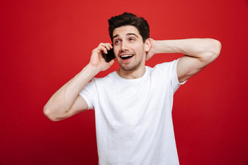 Portrait of a smiling young man in white t-shirt talking