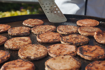 Frying hamburger meat. Hotel and restaurant food. Unhealthy food