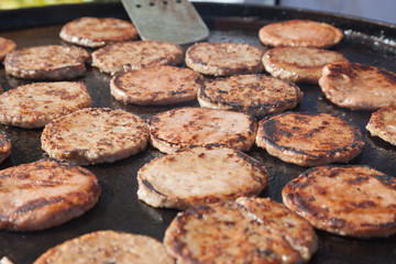 Frying hamburger meat. Hotel and restaurant food. Unhealthy food