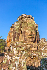 Face of Lokesvara, one of 200 at Bayon temple of Angkor Thom city of ancient Khmer empire. Tourist...