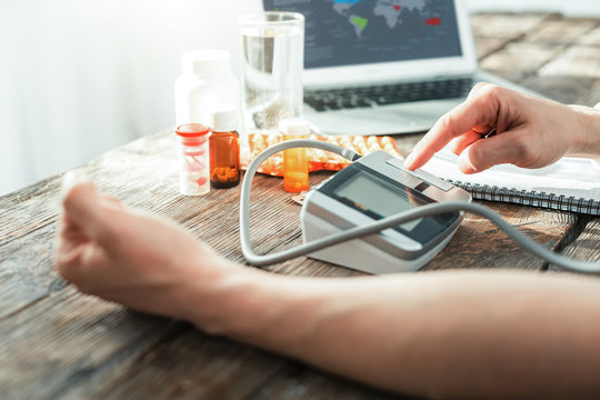 Helpful gadget. New modern pulsimeter being on the table and showing the result.