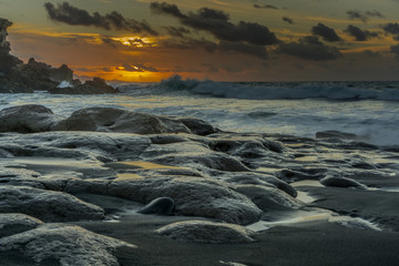 Sunshine on the Atlantic Ocean with big rocks and big waves