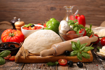 raw dough pizza with ingredient on board