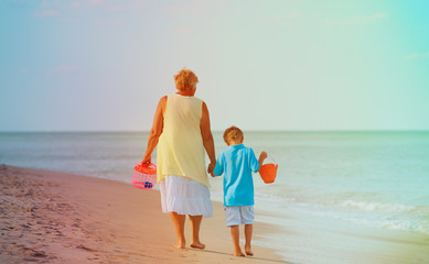 grandmother with grandson walk at beach