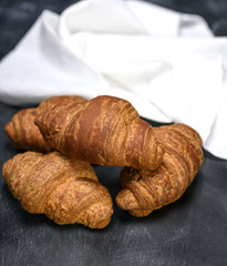 baked croissants on a black wooden table
