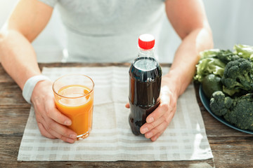 Take yours. Different colorful drinks being on the table opposite each other.