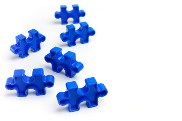 Pieces from a colorful jigsaw puzzle on white background. Break barriers together for autism concept