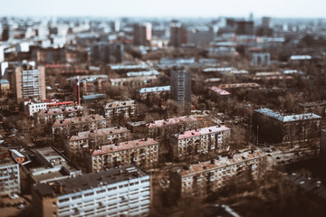 Obraz premium True tilt-shift view from hight point of residential district of consisted of modular prefabricated buildings, five-story block of flats houses of the Khrushchev era in Moscow, Russia; sunny spring