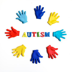 Autism awareness concept with colorful hands on white background. Top view