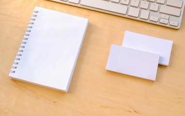 A notebook and business cards on the desktop