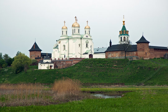 Old monastery on low green hill