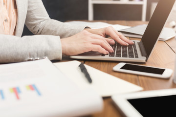 Woman working at office, hands on keyboard close up