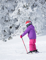 Child skiing on mountain peak