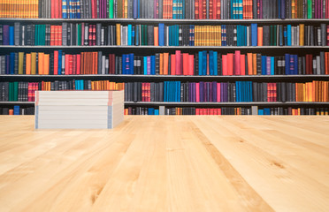 books with copy space - text here, on a wooden deck table on a library background.