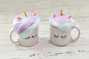 Two mugs with colorful cream in shape of hair
