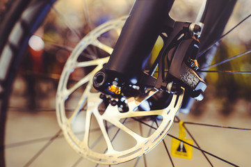 Fototapeta premium Mountain bike front wheel with mechanical disc marriage. Part of Mountain Bike brake in close up