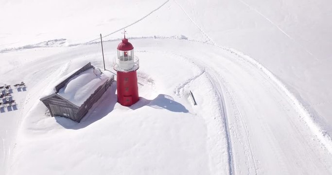 Aerial shot of a lighthouse in a ski resort in Oberalp Pass on a winter day