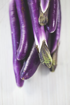 small aubergines on white background