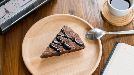 chocolate brownie cake with coffee on wooden table for relaxation time at coffee cafe