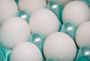 A close up of white eggs in a carton