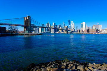 Lower Manhattan Downtown skyline panorama from Brooklyn Bridge Park riverbank, New York City, USA
