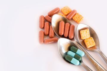 Drugs in spoon,Colorful of oral medications on White Background,drugs or pills health care concept
