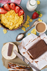 Chocolate butter, cornflakes with fresh strawberries, bottled milk, fresh pastries. Fresh, nutritious Breakfast. The view from the top.