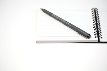 notebook and pen on White background