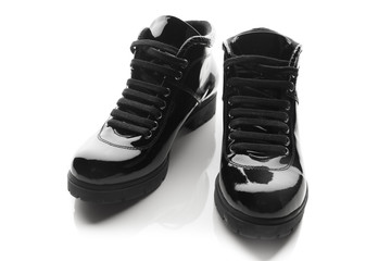 black varnished patent leather shoes isolated on white