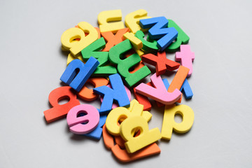 A lot of colorful letters of polystyrene on a white background.