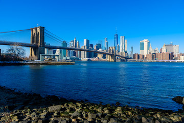 Lower Manhattan Downtown skyline panorama from Brooklyn Bridge Park riverbank, New York City, USA