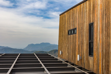 The modern balcony with landscape mountain and blue sky in background.