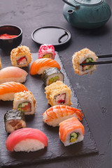 Set of sushi maki and rolls on gray background