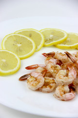 seafood. shrimp on a plate with lemon.