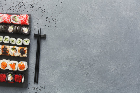 Set of sushi maki and rolls on grey background