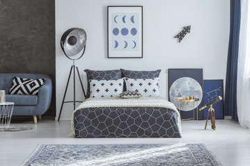 Spacious blue bedroom with telescope