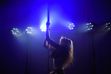 attractive sexy woman pole dancer performing
