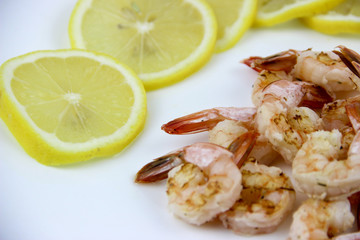 seafood. shrimp on a plate with lemon.