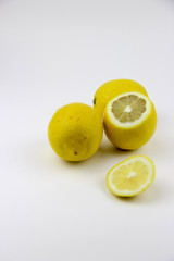 Fototapeta na wymiar bright, yellow lemons. whole and sliced on a plate.