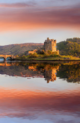 Naklejka na ściany i meble The Eilean Donan Castle with colorful sunset, Highlands of Scotland