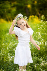 Little girl in a field with white flowers
